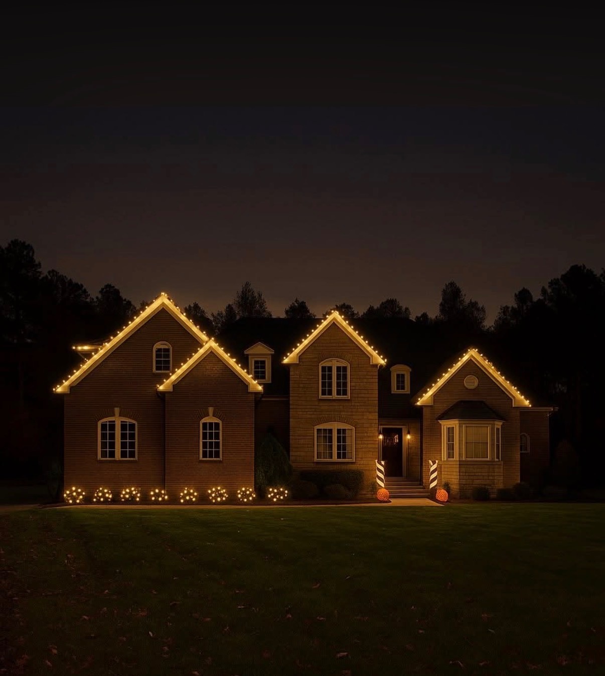 Warm white holiday lights tracing the roofline of a two-story home